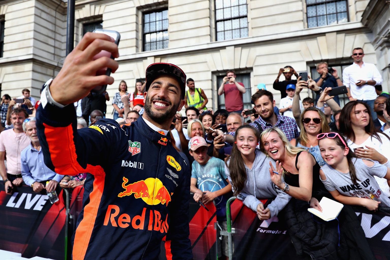 LONDON, ENGLAND - JULY 12:  Daniel Ricciardo of Australia and Red Bull Racing takes a selfie with fans during F1 Live London at Trafalgar Square on July 12, 2017 in London, England.  F1 Live London, the first time in Formula 1 history that all 10 teams come together outside of a race weekend to put on a show for the public in the heart of London.  (Photo by Clive Mason/Getty Images for Formula 1) *** Local Caption *** Daniel Ricciardo