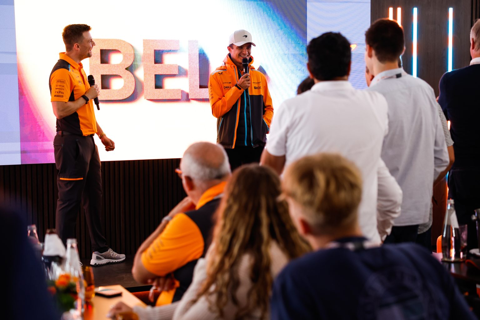 Lando Norris, McLaren, speaks to guests at a McLaren Paddock Club event
